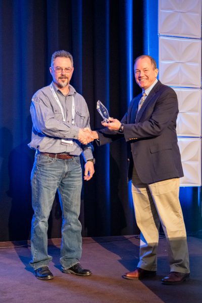 2019 CEC Innovation Award -- Neil Kostelecky accepts the award from Paul Tomiczek III, Chief Technology Officer